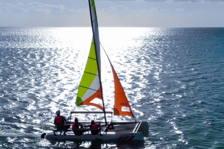 a man riding on the back of a boat in a body of water